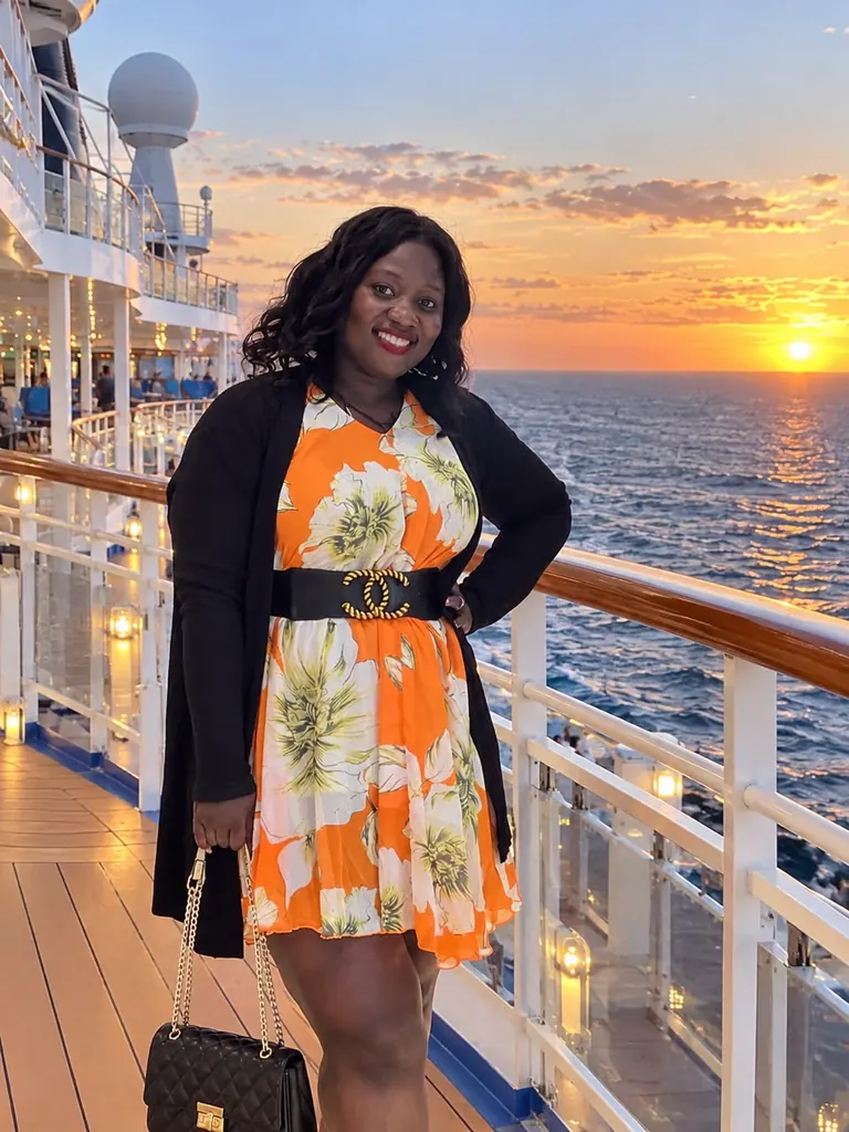 Irene on a cruise ship deck at sunset, with the ocean behind her
